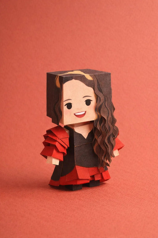 Cube-headed cardboard paper toy character on colorful studio background, showing photo-to-figure style with clean negative space: Rosalia