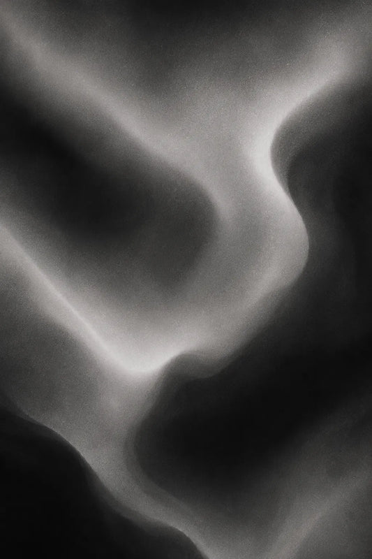 Example output from the Ethereal Grain Gradients ChatGPT prompt: an atmospheric grainy gradient background in black-and-white tones with smooth organic flow, cinematic transitions and soft analog grain.