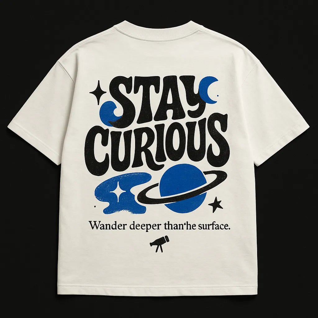 Example output from the Minimal Concept T Shirt Back Prints ChatGPT prompt: premium flat-lay T-shirt mockups with bold centered quotes, minimalist concept icons, vivid highlights, and high-resolution fabric texture rendering. Stay Curious.