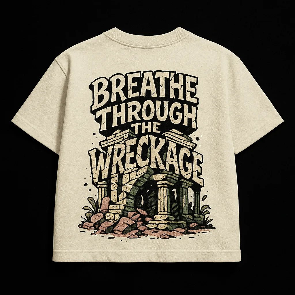 Example output from the Oversized Streetwear T Shirts Back Art ChatGPT prompt: bold graphic T-shirt mockups with screenprint-style back quotes, flat-lay perspective, and expressive pop-style illustrations on cotton fabric. Breathe Through the Wreckage.