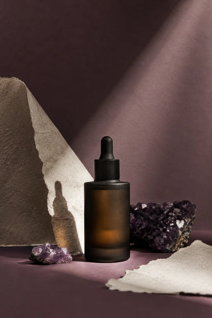 Example output from the Editorial Beauty Product Photos ChatGPT prompt: a luxury editorial skincare product photo with dramatic sunlight, geometric shadows and a serum dropper bottle on a stone plinth in warm muted tones.