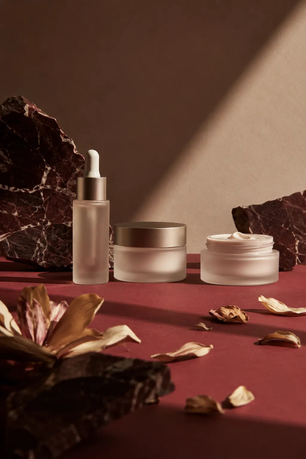 Example output from the Editorial Beauty Product Photos ChatGPT prompt: a luxury editorial skincare product photo with dramatic sunlight, geometric shadows and a refined premium product composition in muted tones.