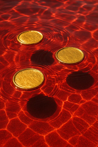 Example output from the Floating Half Submerged 3 Object Shot ChatGPT prompt: photorealistic render of Gold Coins.