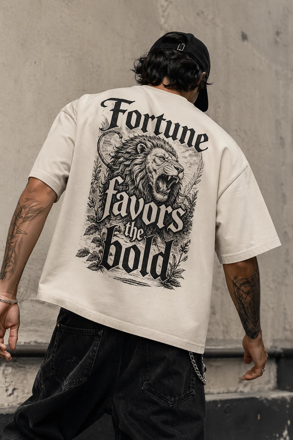 Example output from the Heritage Back Print Tee Designs ChatGPT prompt: a cream oversized tee with a Fortune Favors The Bold back print featuring an engraved lion illustration.