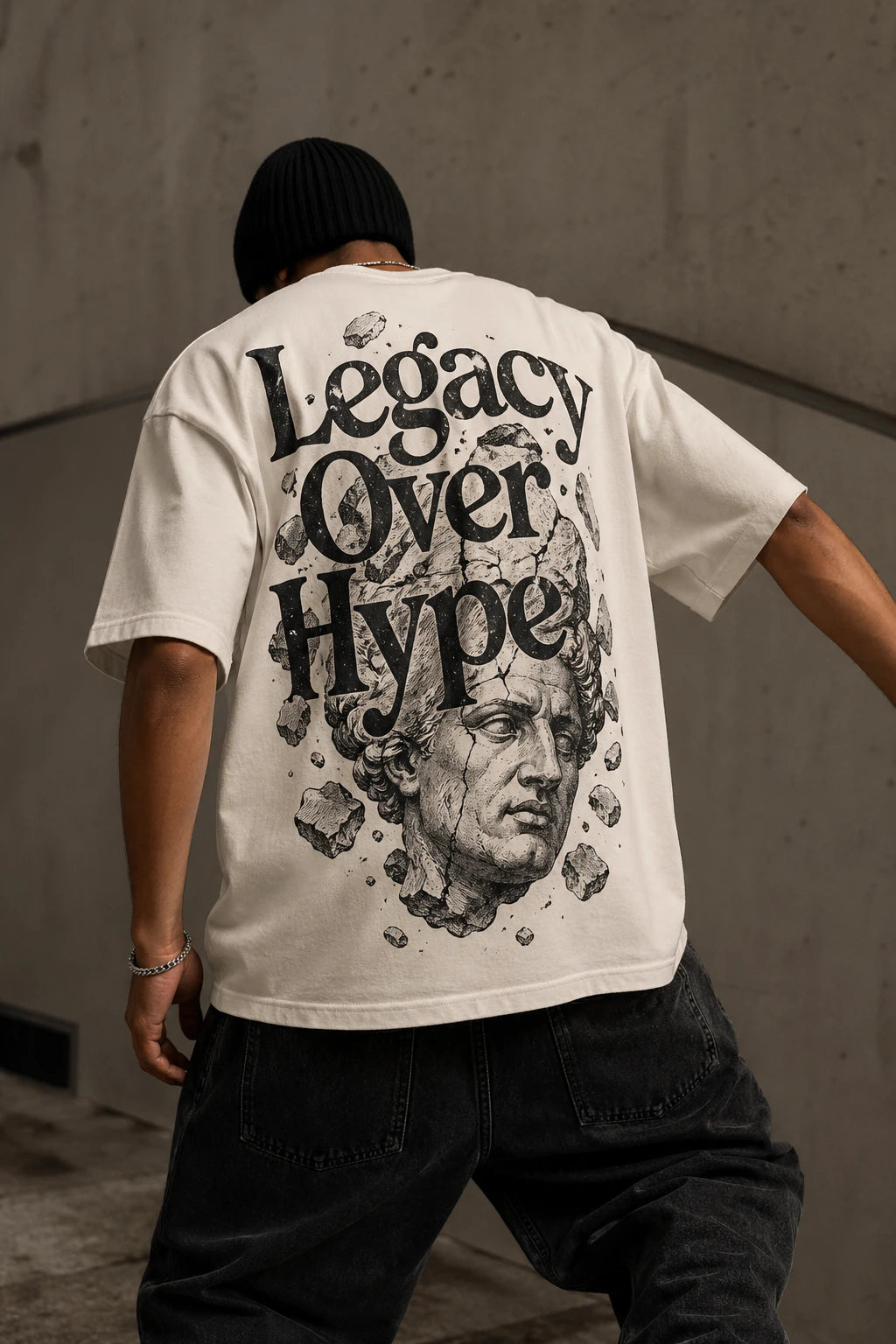 Example output from the Heritage Back Print Tee Designs ChatGPT prompt: a cream oversized tee with a Legacy Over Hype back print featuring a shattered classical marble bust.
