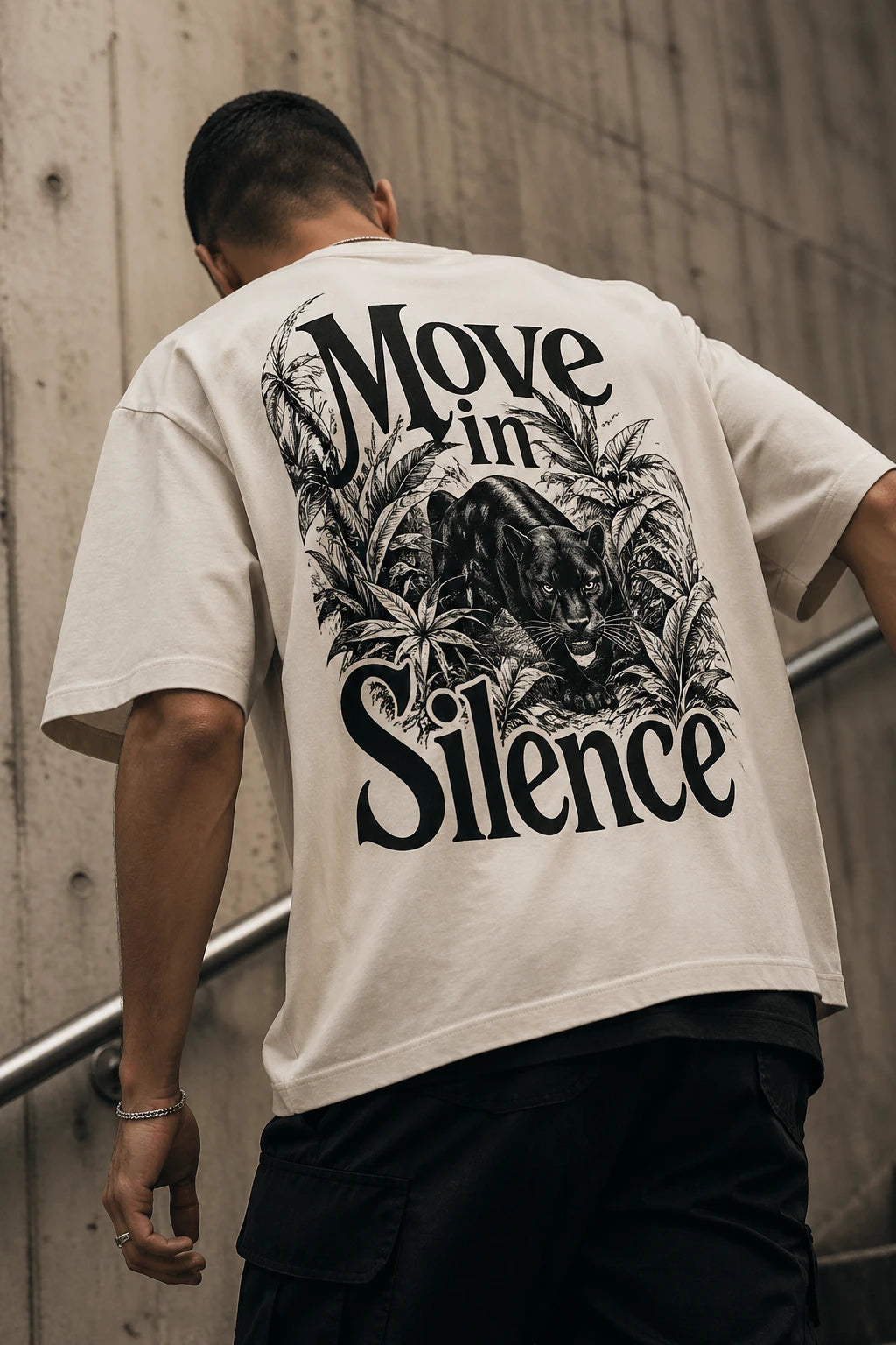 Example output from the Heritage Back Print Tee Designs ChatGPT prompt: a cream oversized tee with a Move In Silence back print featuring a panther stalking through foliage.
