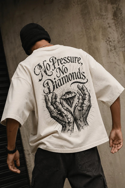 Example output from the Heritage Back Print Tee Designs ChatGPT prompt: a cream oversized tee with a No Pressure No Diamonds heritage back print, shot from behind against a concrete backdrop.