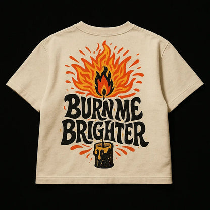 Example output from the Oversized Streetwear T Shirts Back Art ChatGPT prompt: bold graphic T-shirt mockups with screenprint-style back quotes, flat-lay perspective, and expressive pop-style illustrations on cotton fabric.Burn me Brighter.